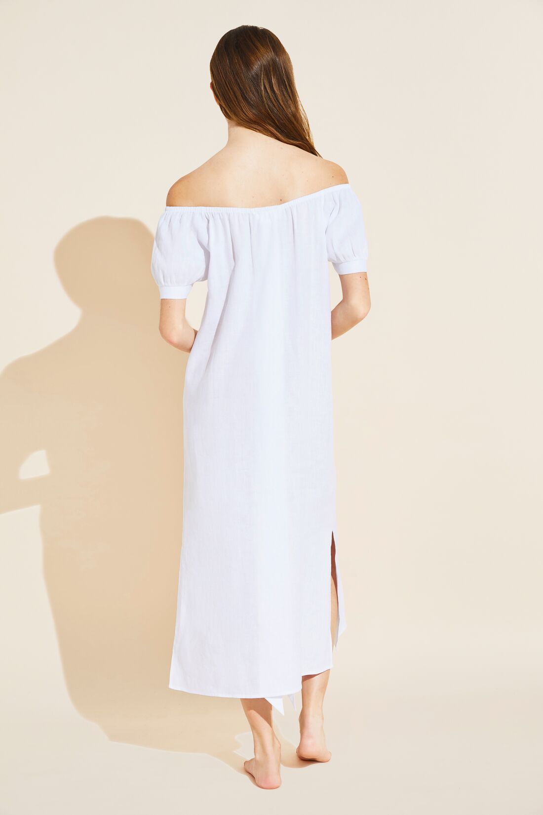 Model wears Harper Linen Dress in white.