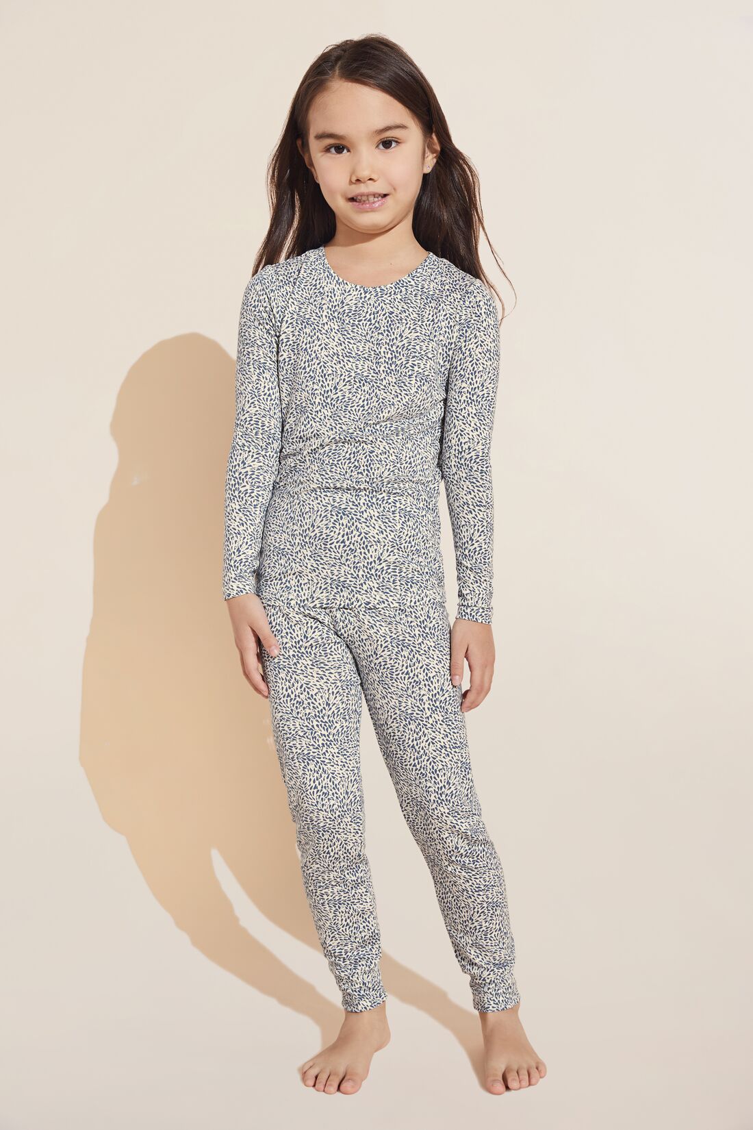 Model wears Kids Printed TENCEL™ Modal Unisex Long PJ Set in animale coastal blue.