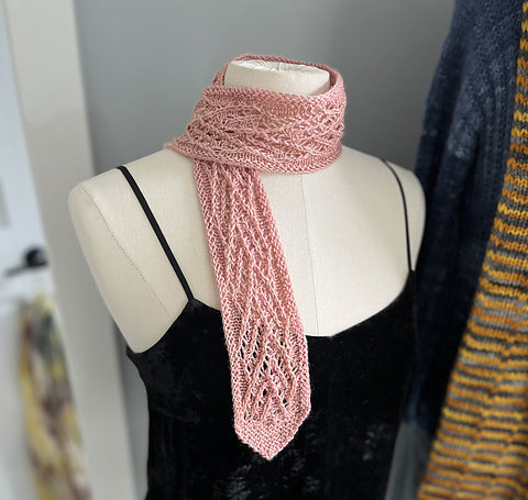 Lor's pink Versailles Scarf styled on a mannequin with a black tank top