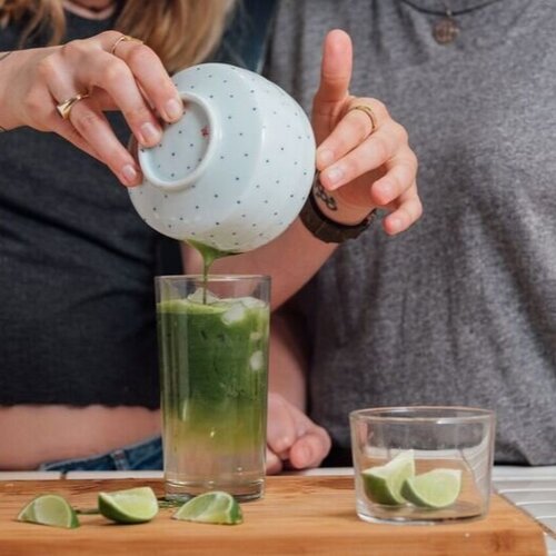 Matcha being poured into cocktail