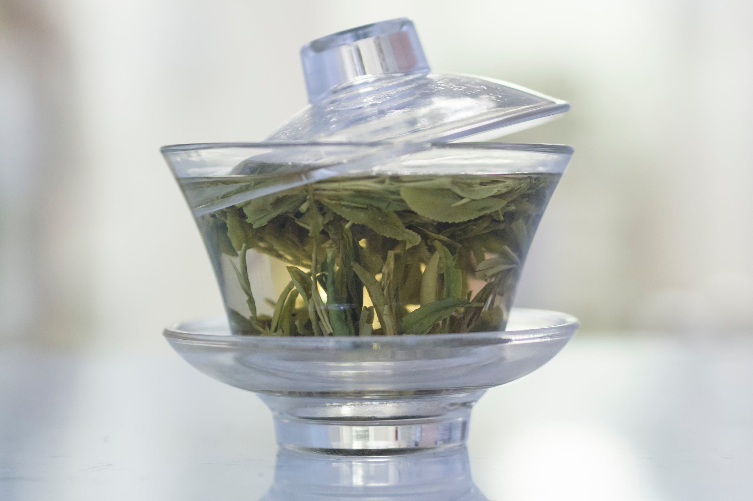 Tea leaves brewing in gaiwan.