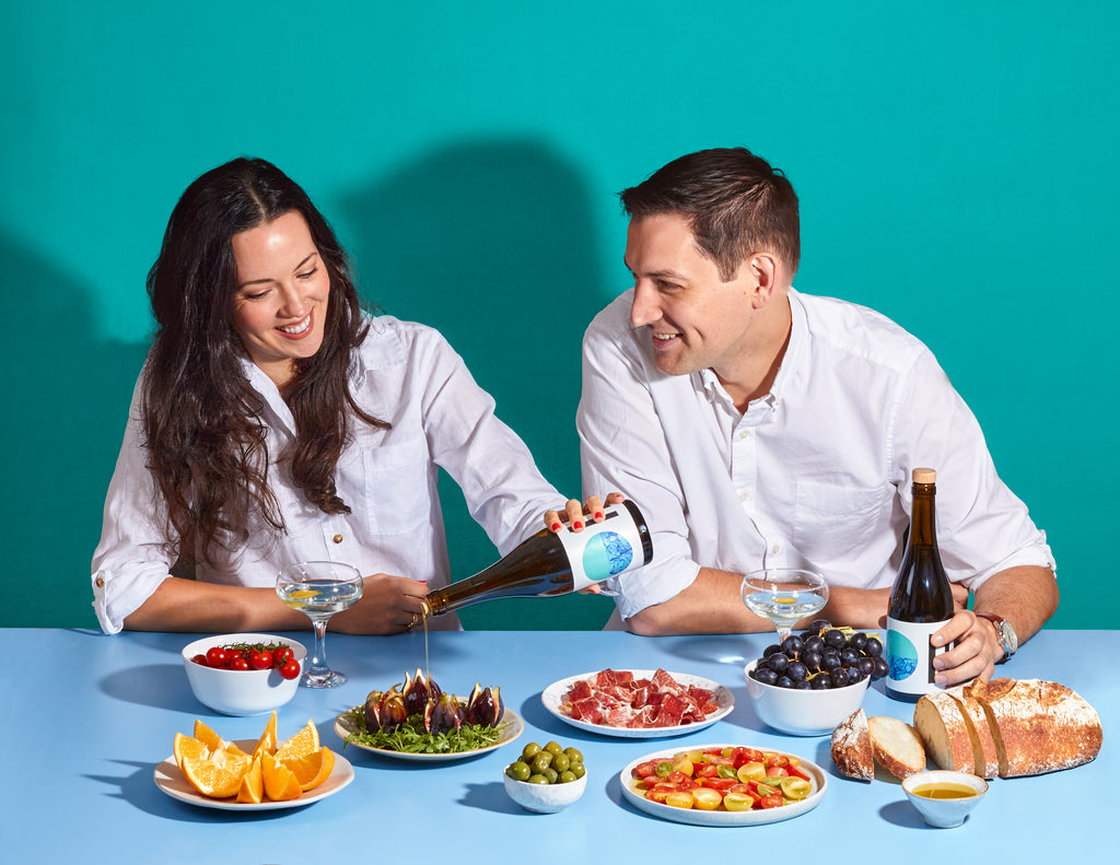 Citizens of Soil founders sat at a blue table pouring Olive oil over various foods