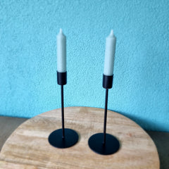 Black industrial candlesticks on wooden platform