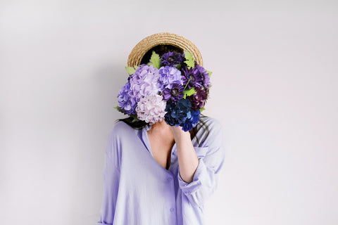 A woman standing in front of lavender flowers, symbolising the calm and peaceful nature of dreams