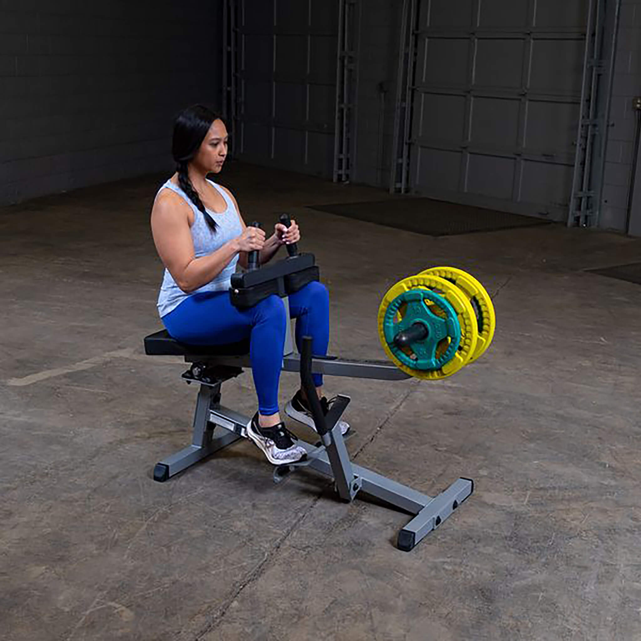 body solid commercial seated calf raise woman calf raise green and yellow plates