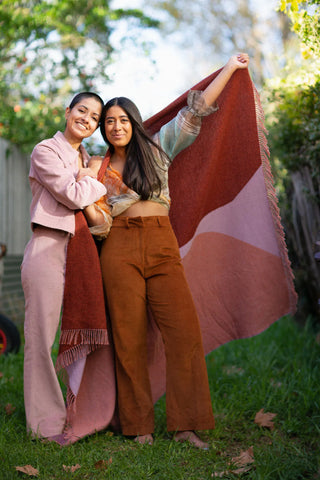 Two women holding a SelJak Recycled Wool Blanket