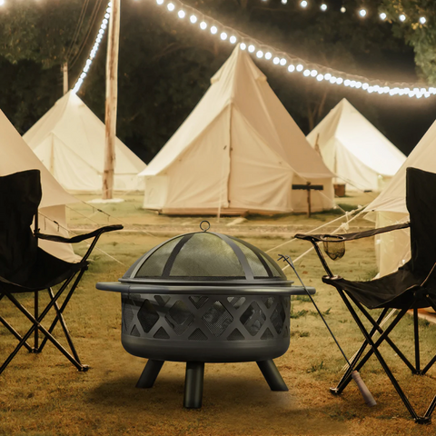 Wood burning campfire in front of tents