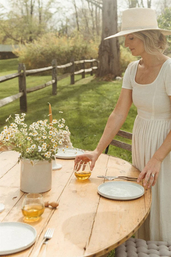 Woman setting the table outdoors