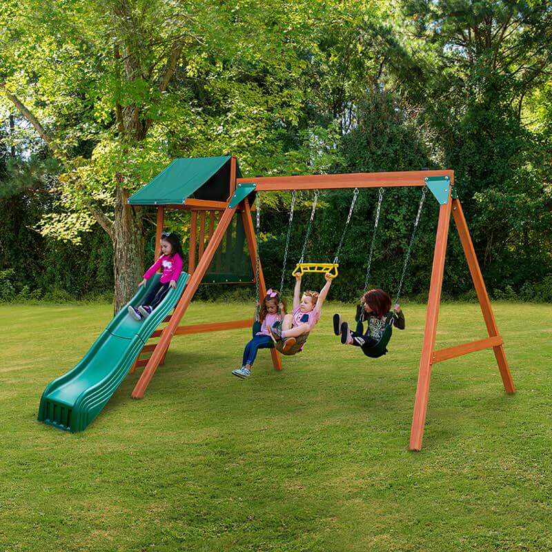 Wooden swing set with slide add on in a backyard with kids