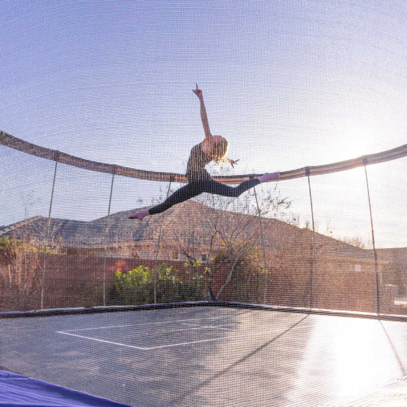 Skywalker Trampoline's 15' Premium Square Trampoline - LMG-SPTCS1515 with girl jumping