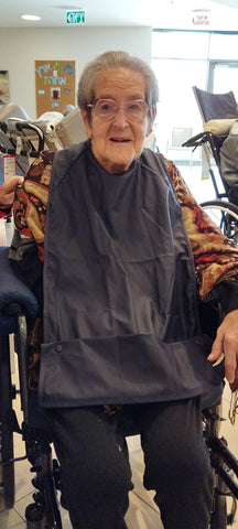 woman wearing reusable adult bib for dementia patients