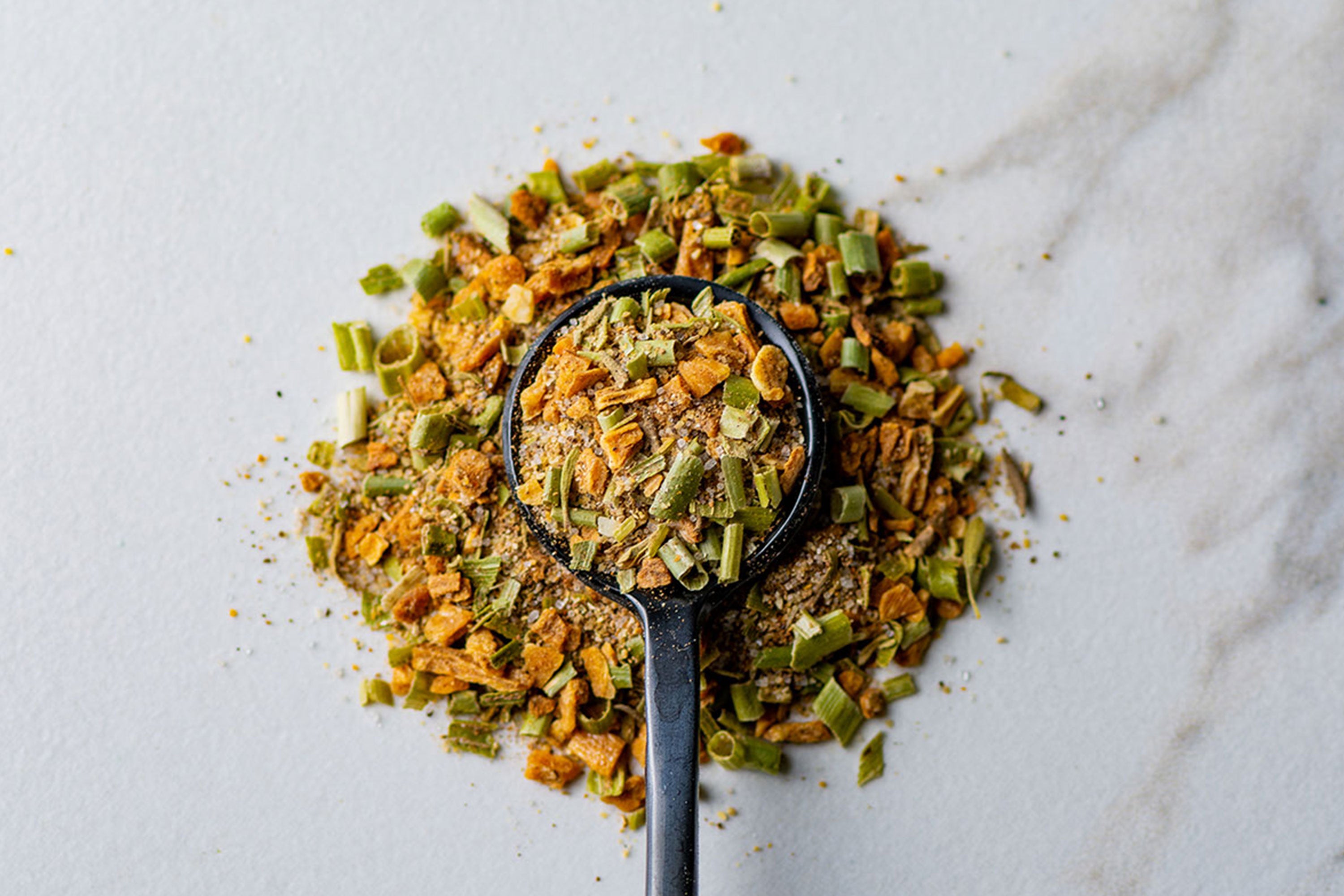 Jamaican Jerk Seasoning in a spoon on marble background