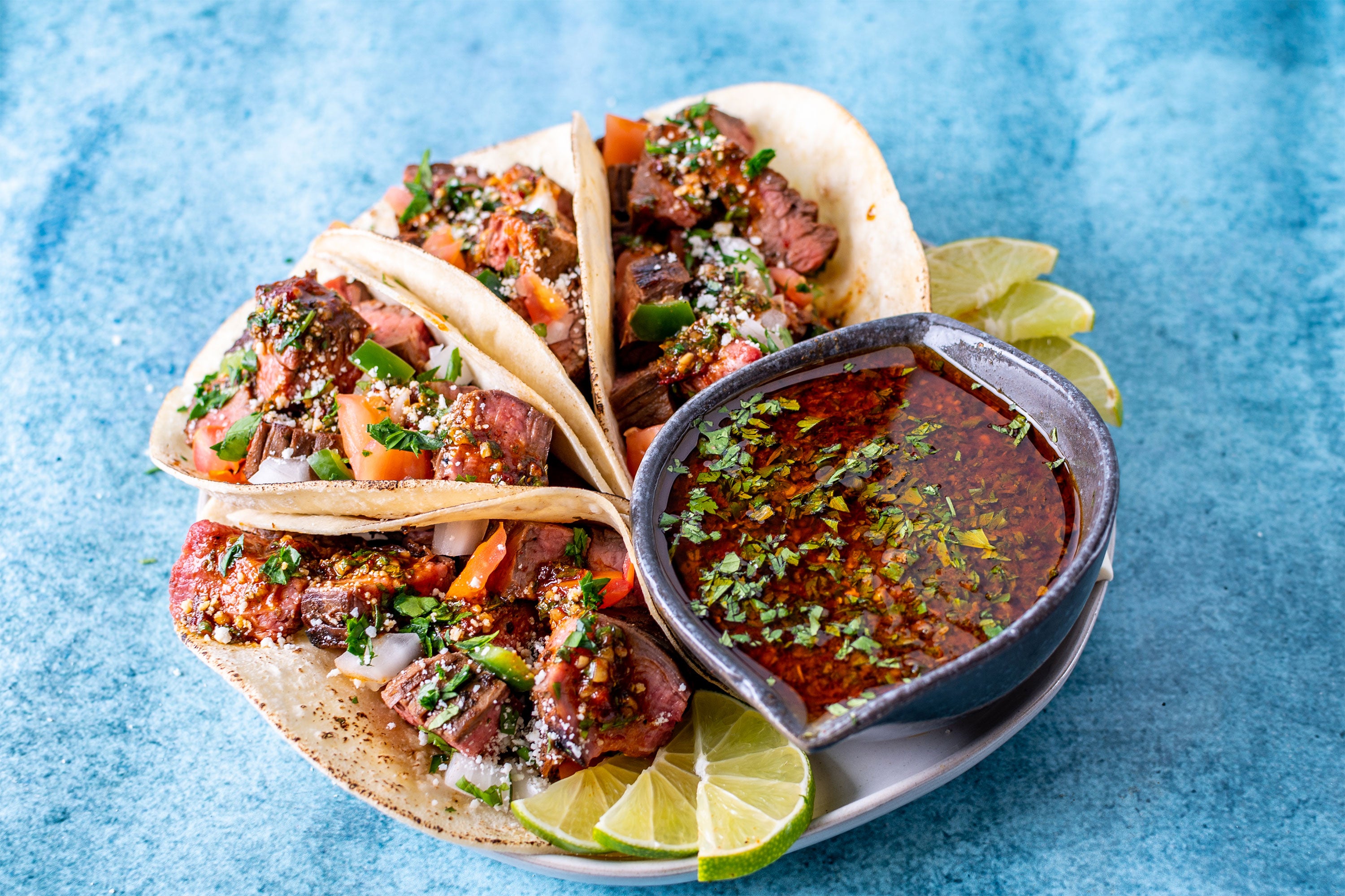 Carne Asada Tacos on bright blue background