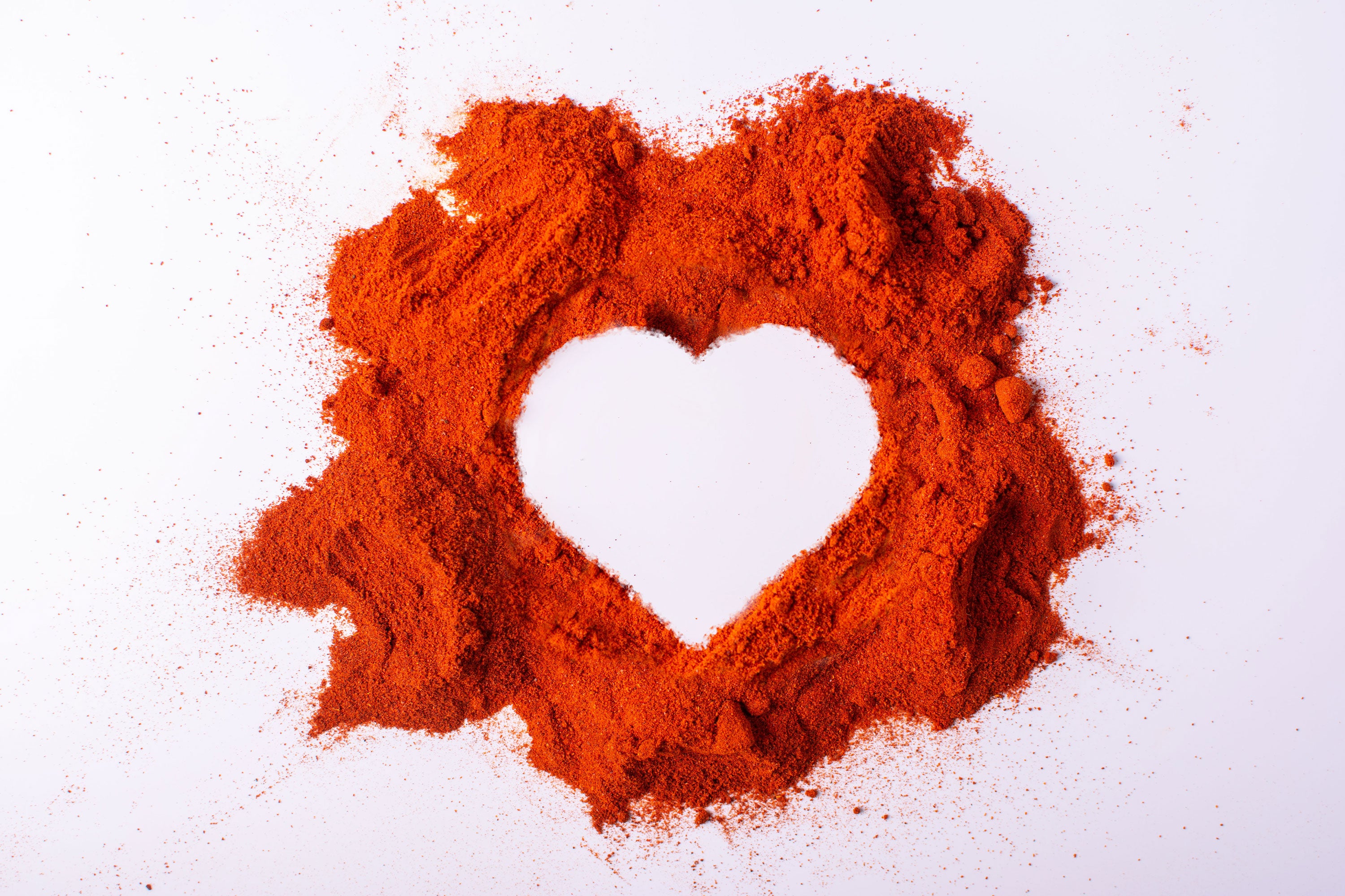 Pile of paprika with a white heart in the middle