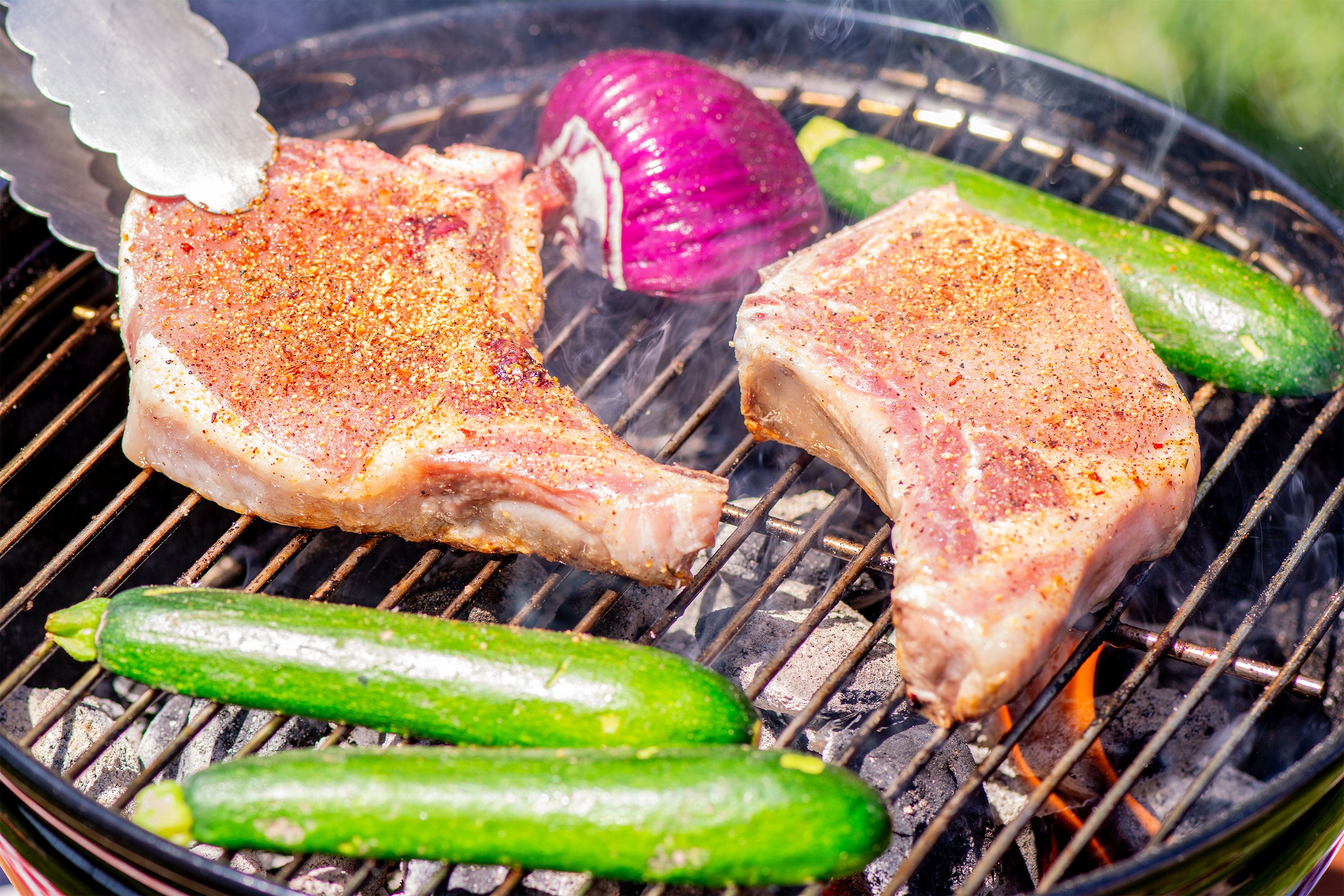 Pork chops on the grill with vegetables