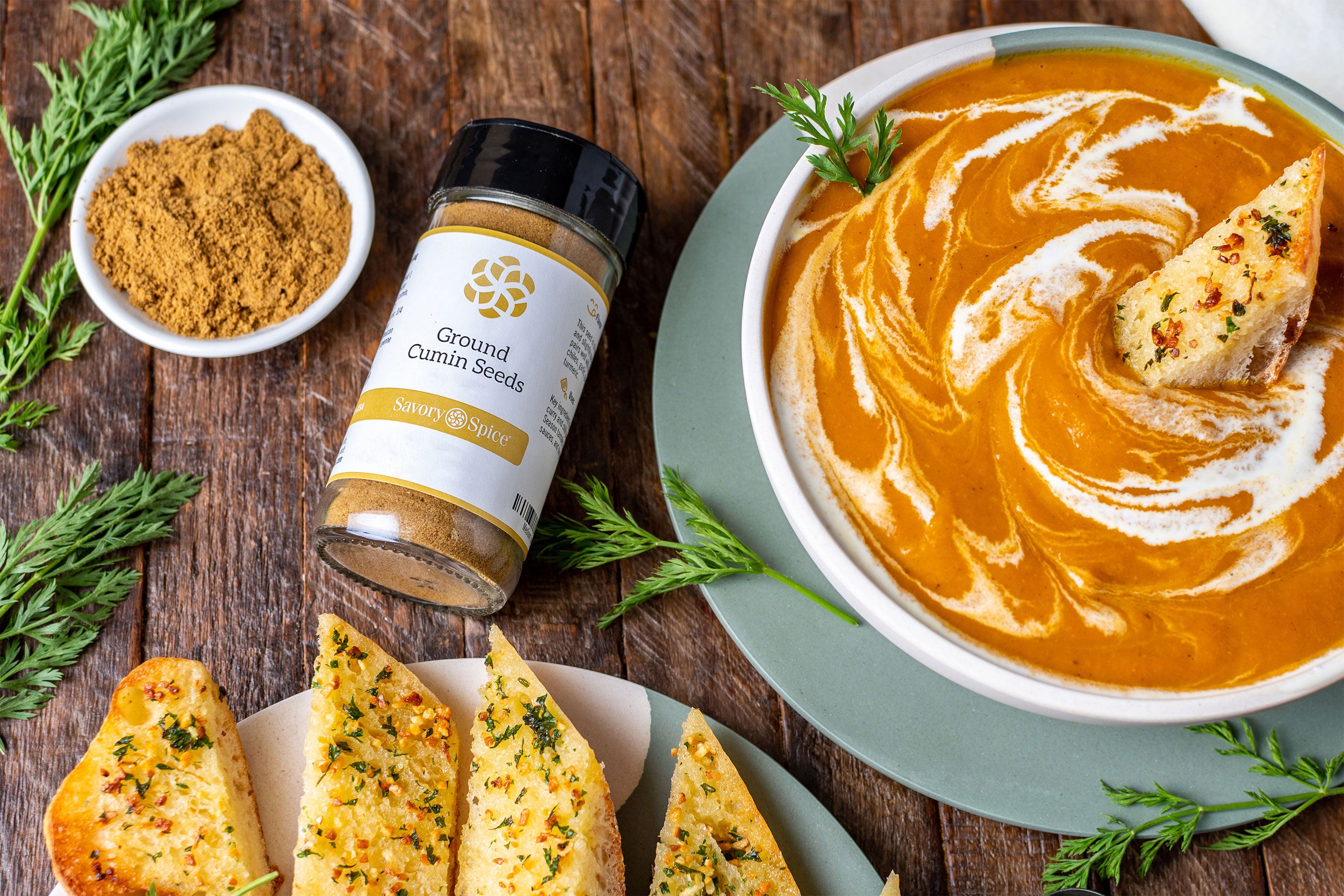 Jar of cumin with cumin carrot soup and garlic bread