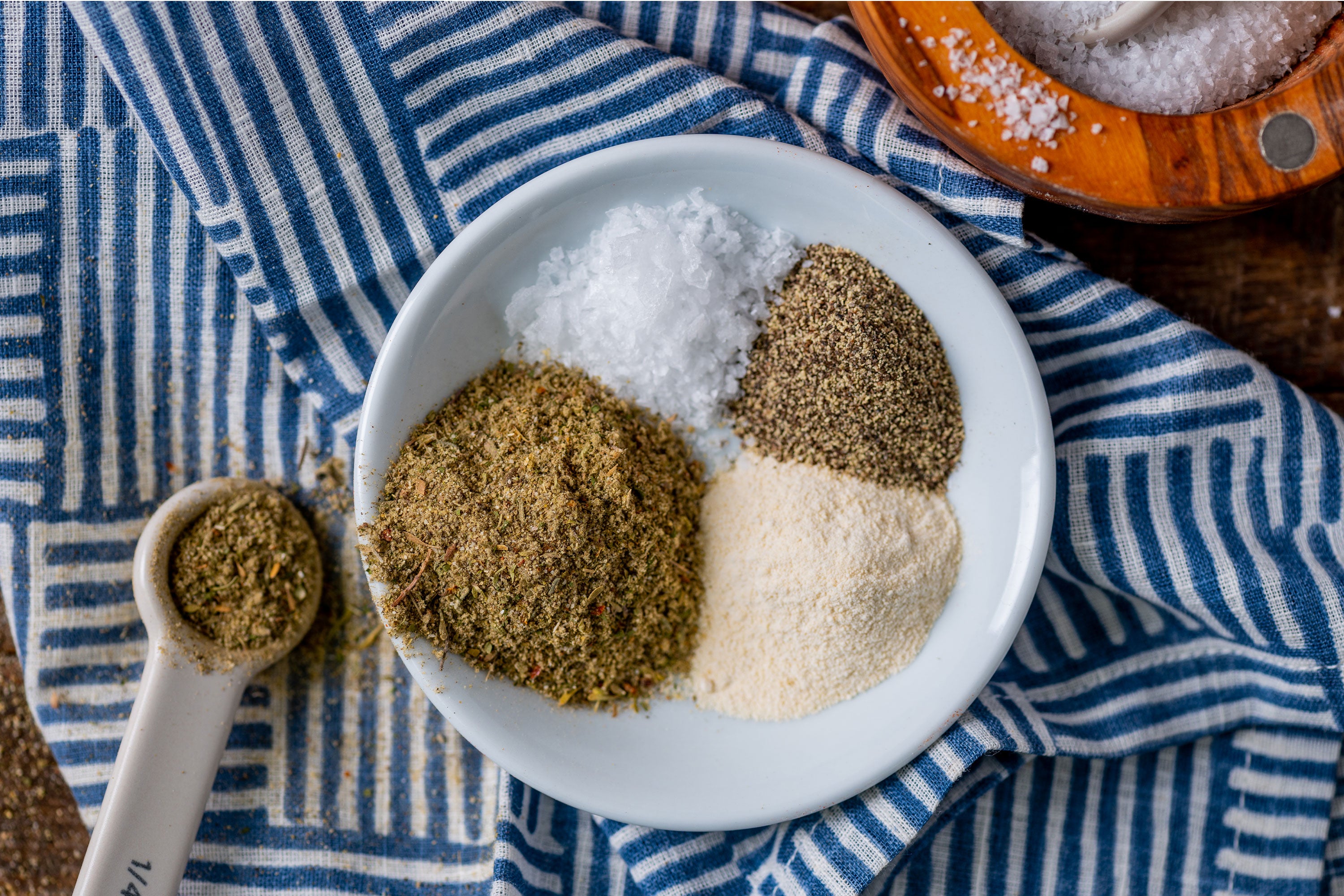 Bowl with assorted spices on blue and white napkin