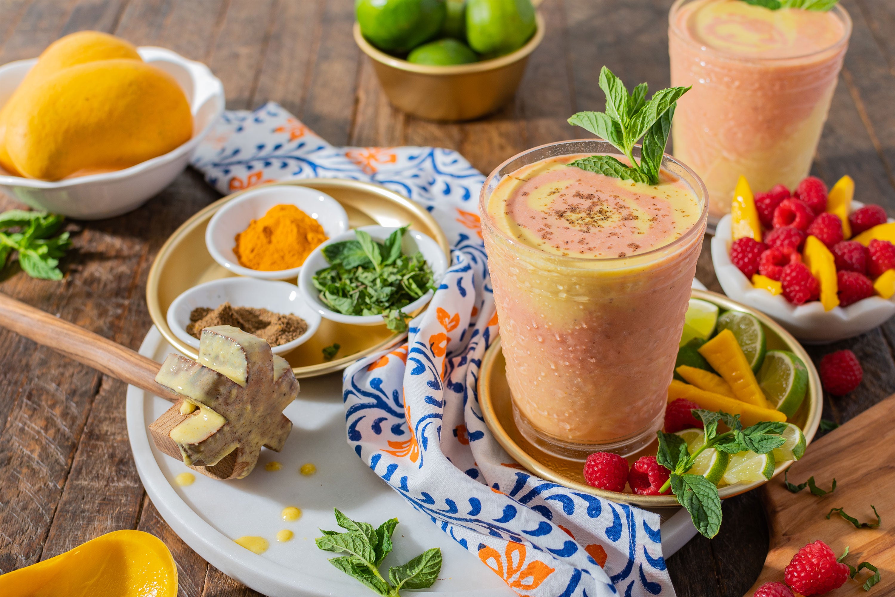 Fruit Masala Lassi surrounded by ingredients and spices