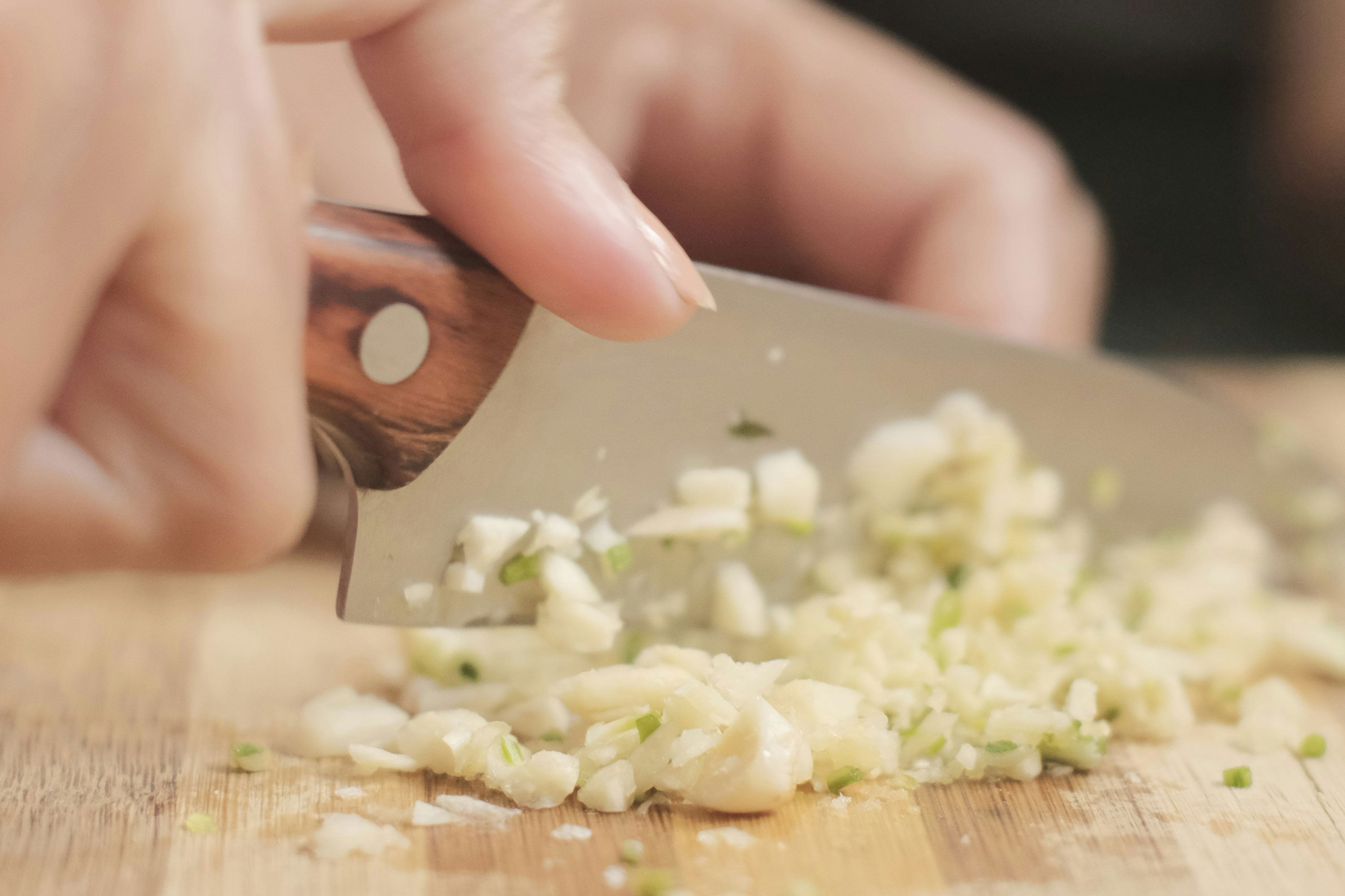 Person mincing garlic
