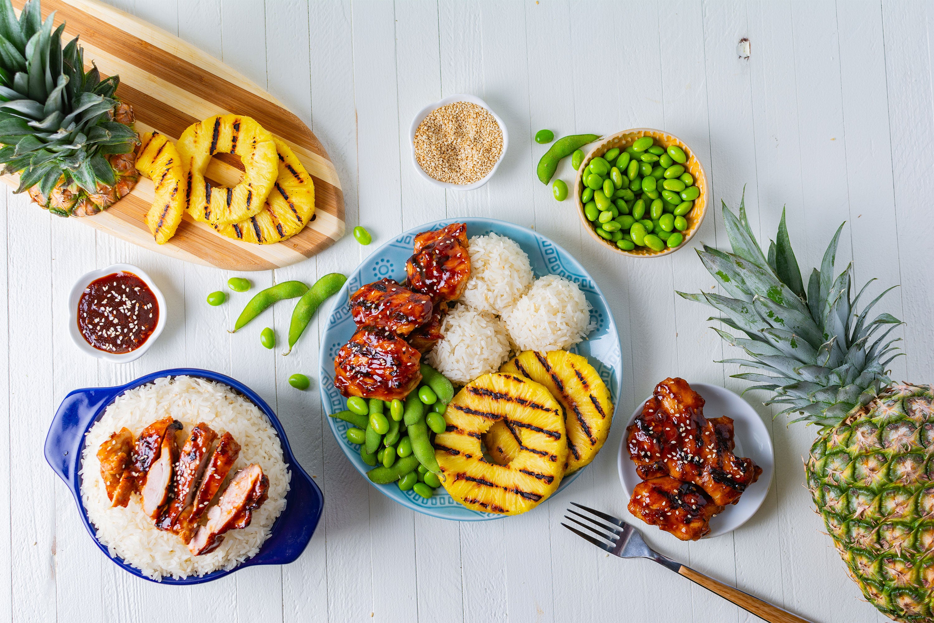 Huli Huli Chicken dinner with grilled pineapple, rice, and edamame