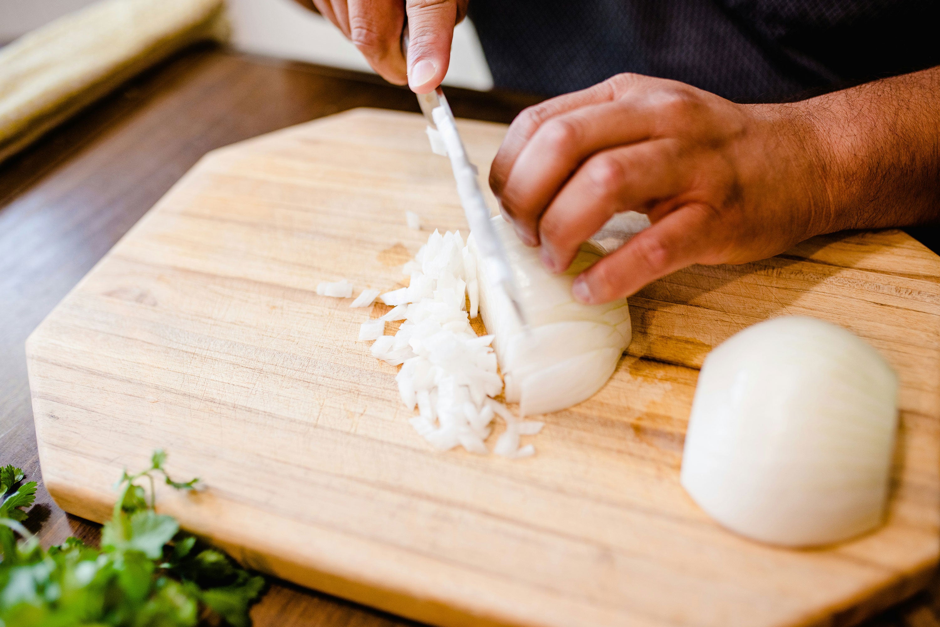 Person cutting an onion