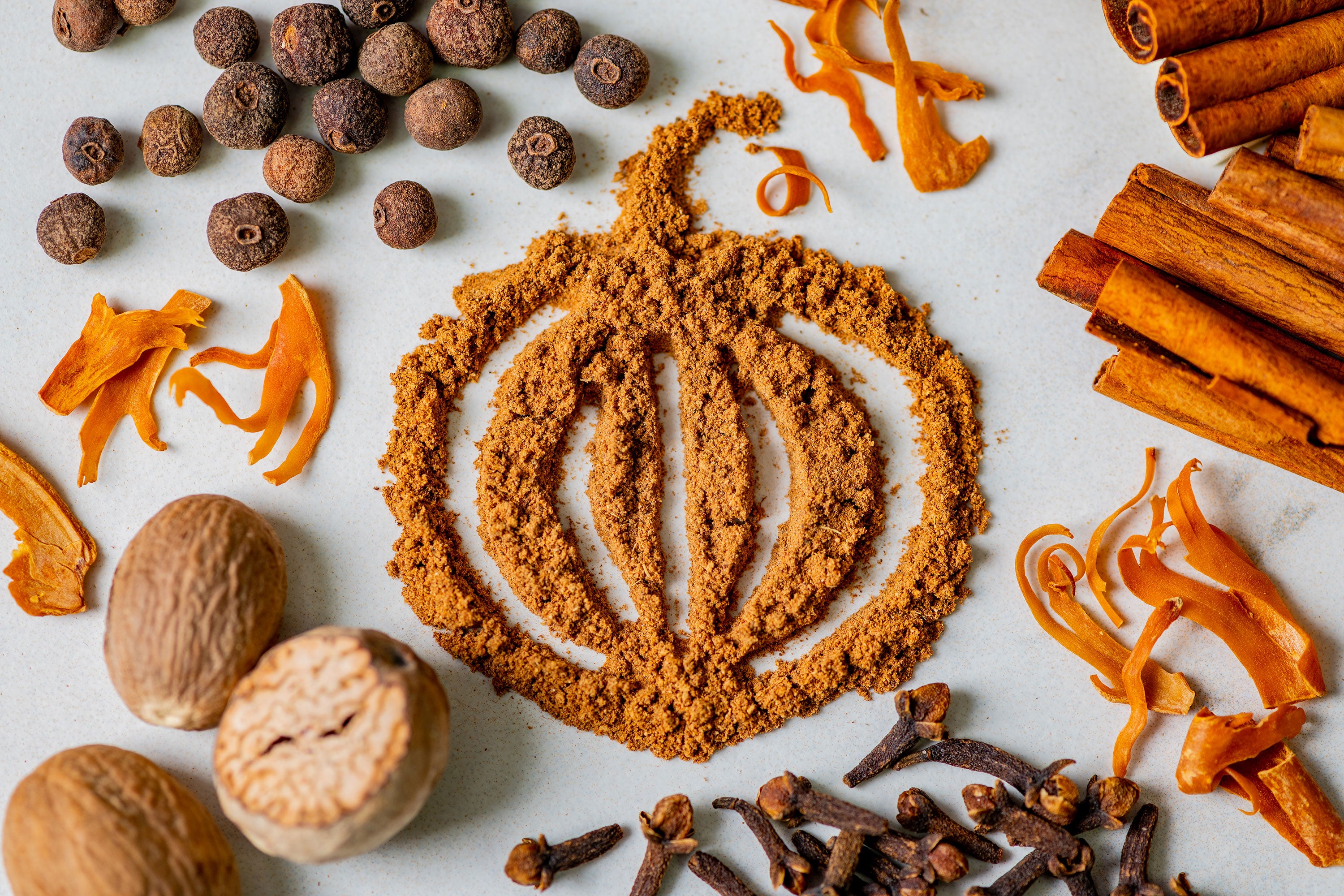 A drawing of a pumpkin made from Pumpkin Pie Spice with whole spices around it