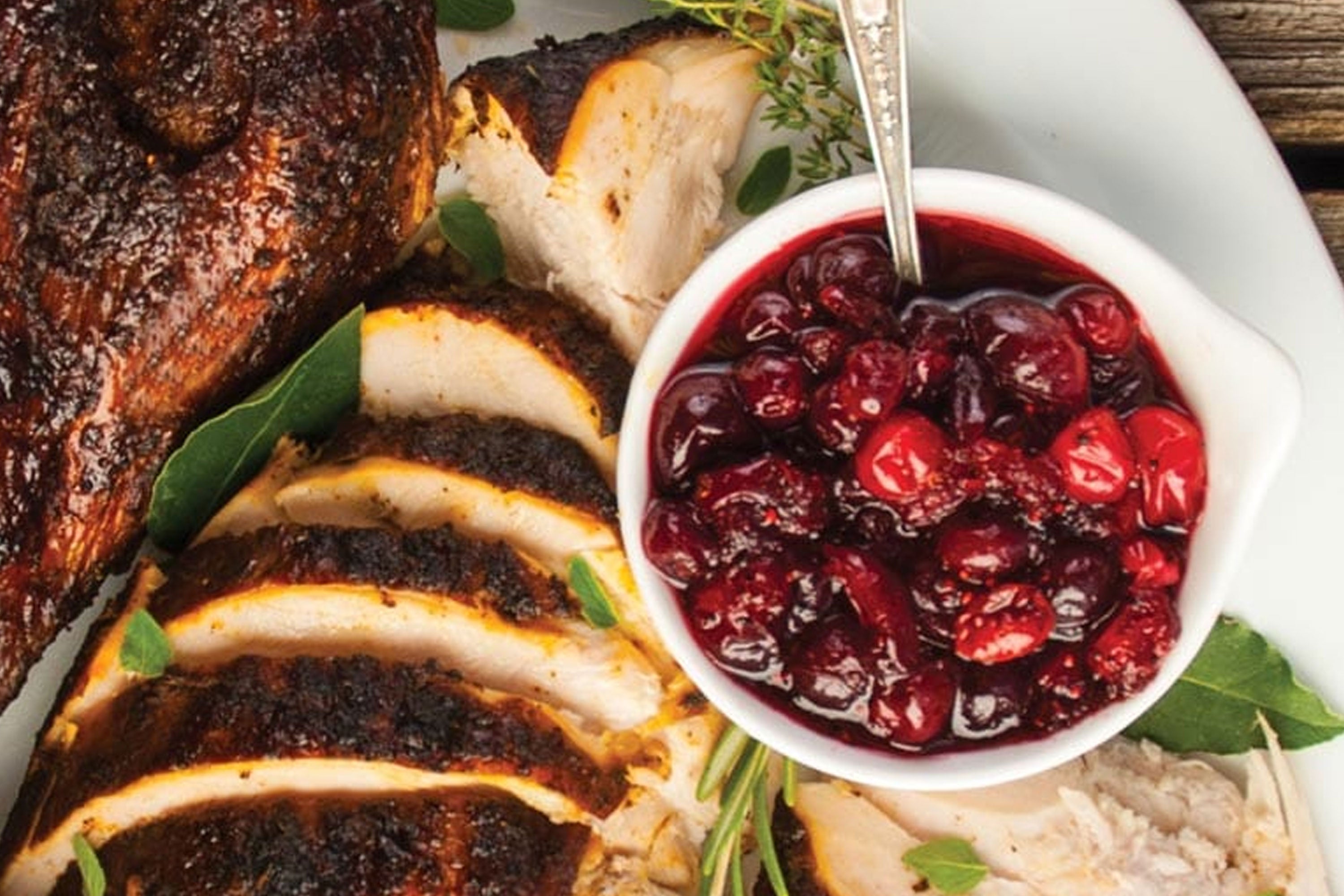 Coffee Spiced Cranberry Sauce on right with sliced turkey on left