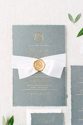 monogram crest wax seal on wedding invitation ribbon