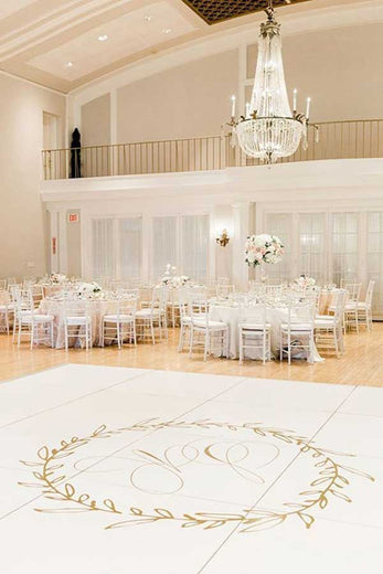 monogrammed dance floor with gold monogram and wreath