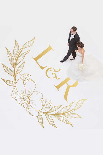 wedding couple walking across gold monogrammed dance floor