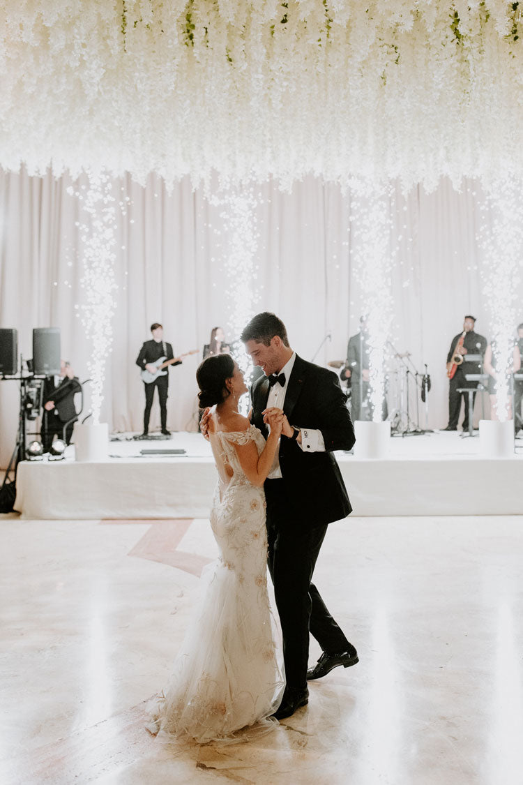 luxe wedding couple dancing under hanging white wisteria