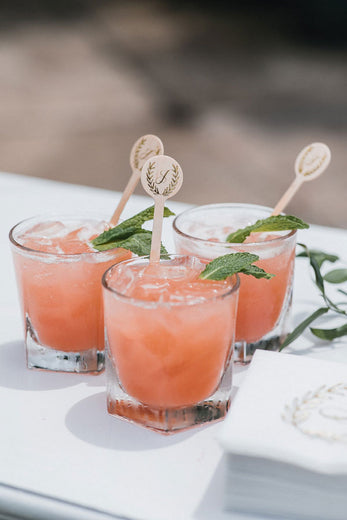 monogrammed wooden drink stirrers in wedding cocktail