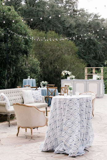 outdoor wedding lounge with vintage furniture and decorative pillows