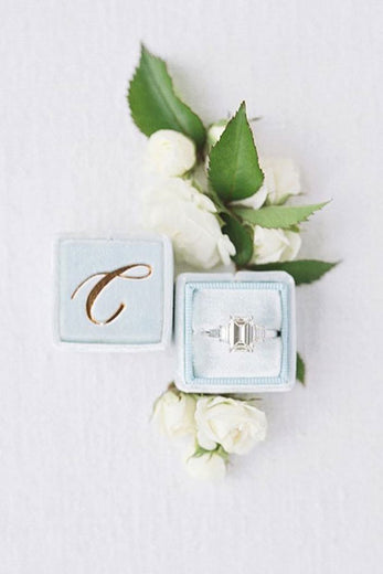 light blue velvet ring box with gold foil monogram