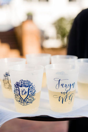 monogrammed plastic cups with blue wedding logo on server tray