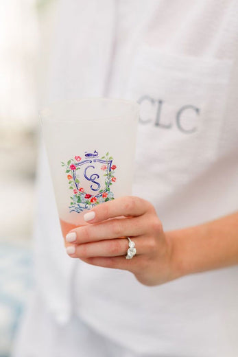 monogrammed plastic cocktail cups with wedding monogram held by the bride