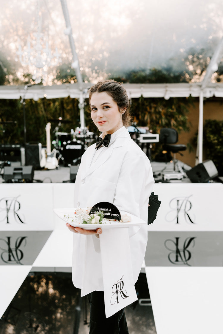 wedding cocktail hour server with monogram tea towel and appetizers