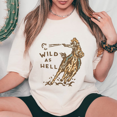 Western graphic t-shirt with cowgirl on horse and wild as hell wording on front