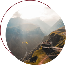 Thrilling image of a paraglider soaring over the breathtaking mountain ranges of Georgia, capturing the adventurous spirit and natural beauty of the region.