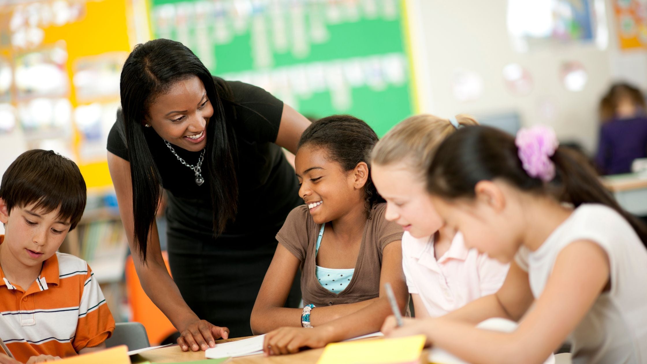 Teacher talking with small group of students