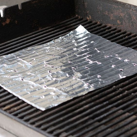 Use a ball of aluminum foil to clean tough, stuck-on residue. Simply crumple the foil and scrub the grates with it.