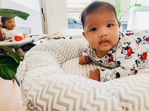 Baby having tummy time on Little Archer & Co. newborn nest