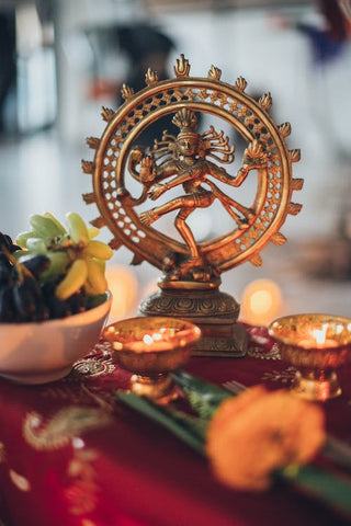 This is a religious depiction from Hinduism of a Shiva Nataraja figurine encompassed by tealights 