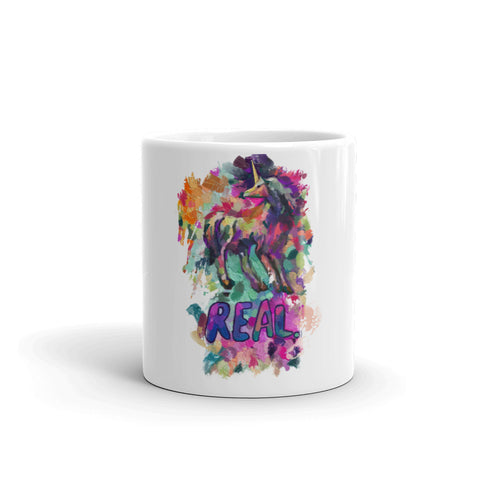 Real Unicorn Apparel's 11 oz. coffee mug of a magical, mythical unicorn with the word "REAL" below the animal.