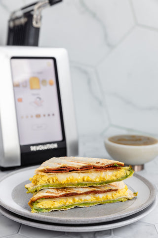 quesadilla cut in half stacked on top of each other showing the cross section. toaster in the background