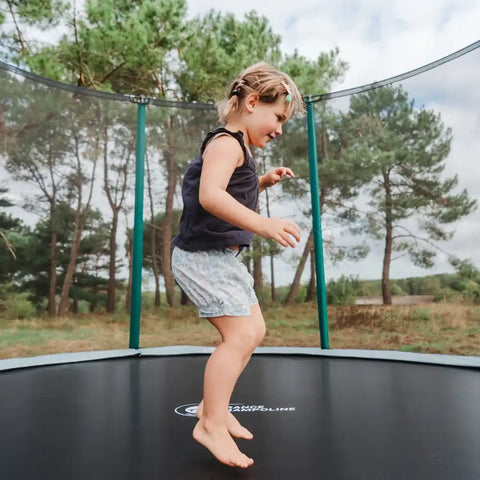 girl jump on outdoor trampoline