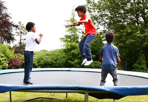kids jump on a trampoline without net