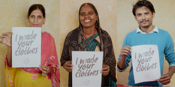 Embroidery artisans holding up a 'I made your clothes' banner