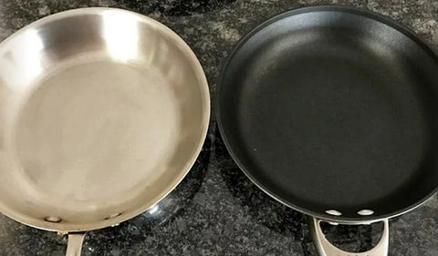 A selection of iron and iron-alloy cooking pots after use in the