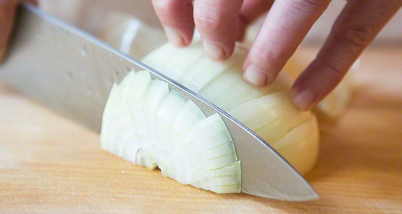 Chopped vs. diced: A chef chops an onion